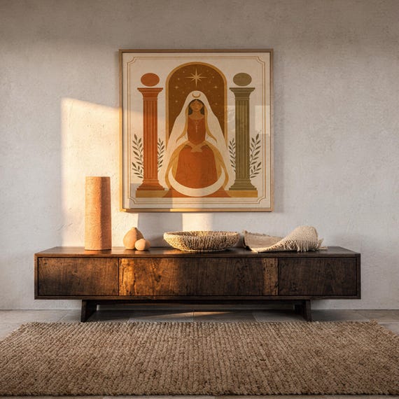 Bohemian architectural vase art print displayed on a dark wooden credenza illuminated by warm golden hour sunlight.