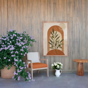 Large terracotta arch poster in cozy living room with orange armchair