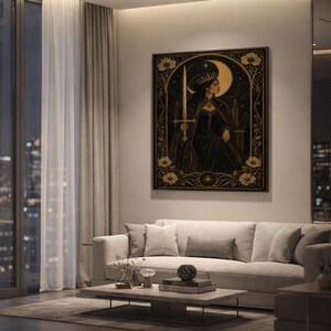 Gothic moon queen wall art print hanging above a light gray sofa in a modern living room with evening city views through tall windows.