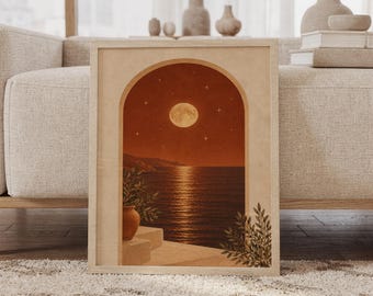 May include: A framed rectangular wall art print featuring an arched window view of a calm sea at night under a full moon and stars. The scene includes a terracotta-colored sky, a dark ocean with moonlight reflection, and potted greenery.