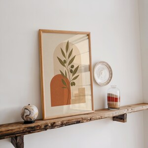 Terracotta arch poster framed on rustic wooden shelf with natural light