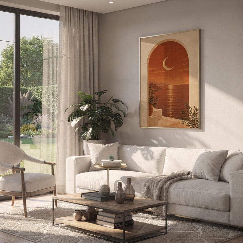 Mediterranean crescent moon arch print hanging above a white sofa in a living room with garden views.