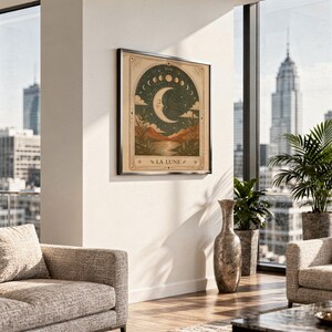 Terracotta celestial moon print framed on wall above sofa in modern high rise apartment.