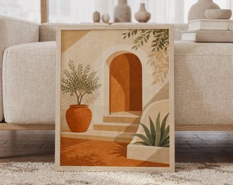 May include: A framed wall art print featuring a terracotta-colored arched doorway with stone steps. The scene includes a potted olive tree in a round orange vessel on the left and a green agave plant on the right, set against a warm beige background.