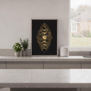 Gold snake moon phase wall art print hanging in a high-rise apartment living room with a city skyline view.