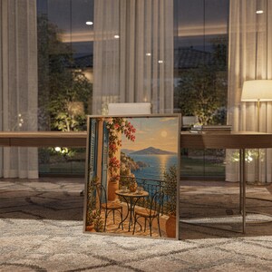 Mediterranean balcony wall art print standing on a wooden desk in a home office in warm evening light.