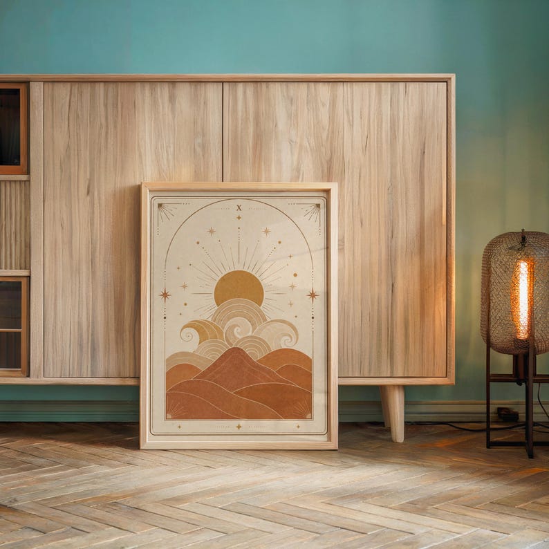 Mid century desert sun wall art framed on wooden console table against accent wall.