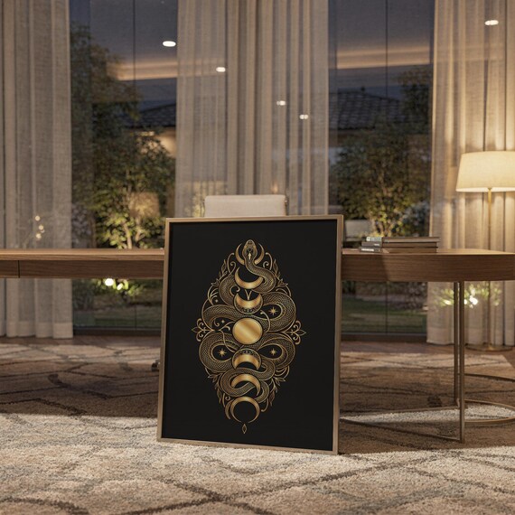 Gold snake moon phase wall art print standing on a wooden desk in a home office in warm evening light.