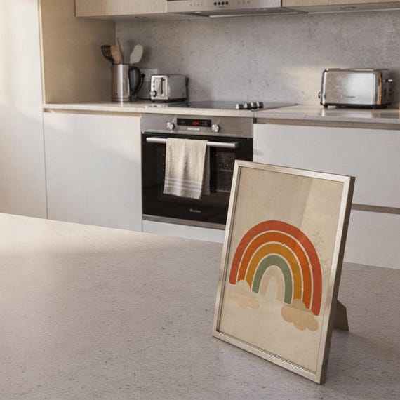 Boho earth tone rainbow print standing on a countertop in a modern white kitchen.