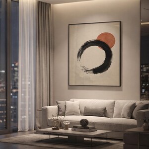 Large framed Ensō circle wall art hanging in a cozy living room with soft evening lighting.