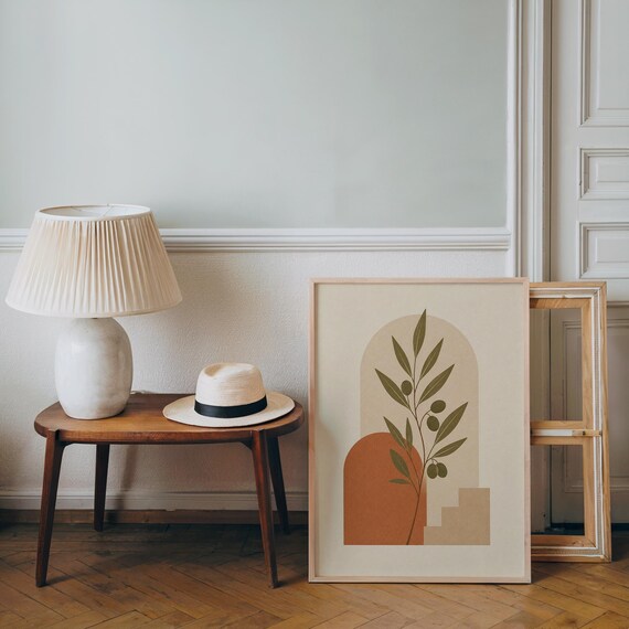 Boho botanical art print framed on wooden side table in minimalist living room