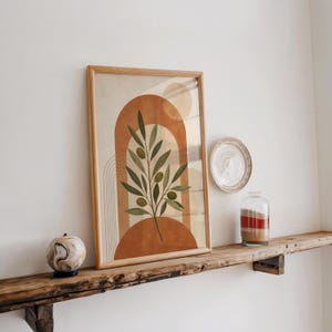 Green olive branch poster on rustic wooden shelf with natural light
