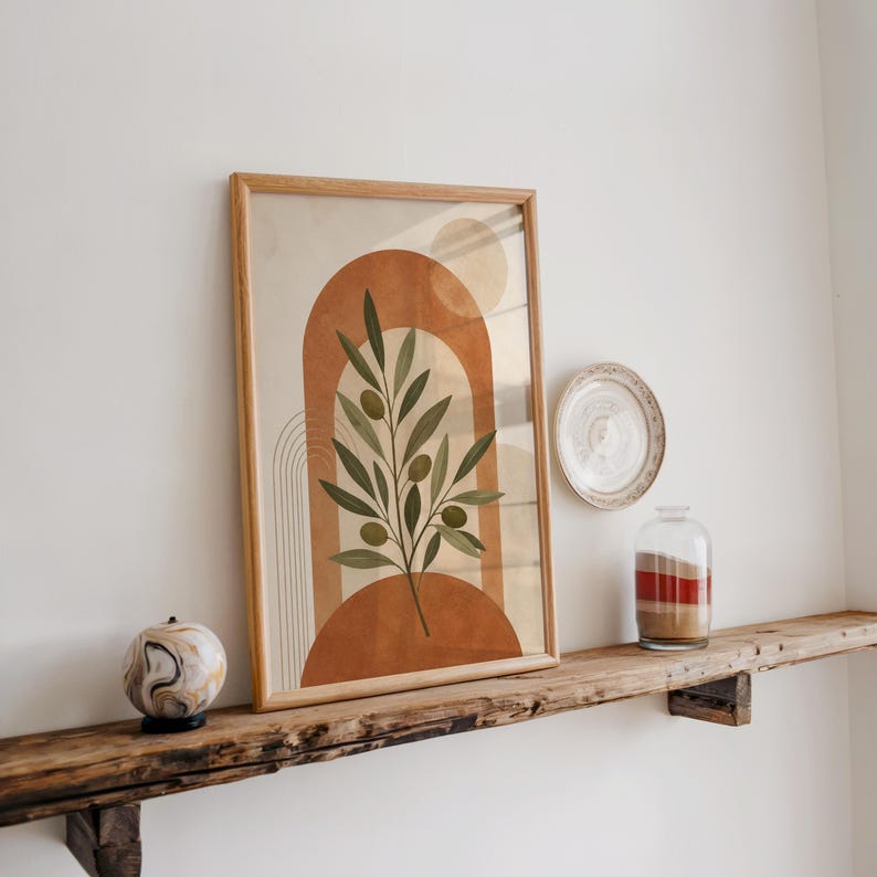 Green olive branch poster on rustic wooden shelf with natural light