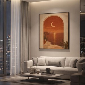 Mediterranean crescent moon arch print showing a crescent moon above a calm coastal sea framed by a sun-washed arch in terracotta, burnt sienna, sand and olive tones, hanging above a light gray sofa in a modern living room with evening city views through tall windows.