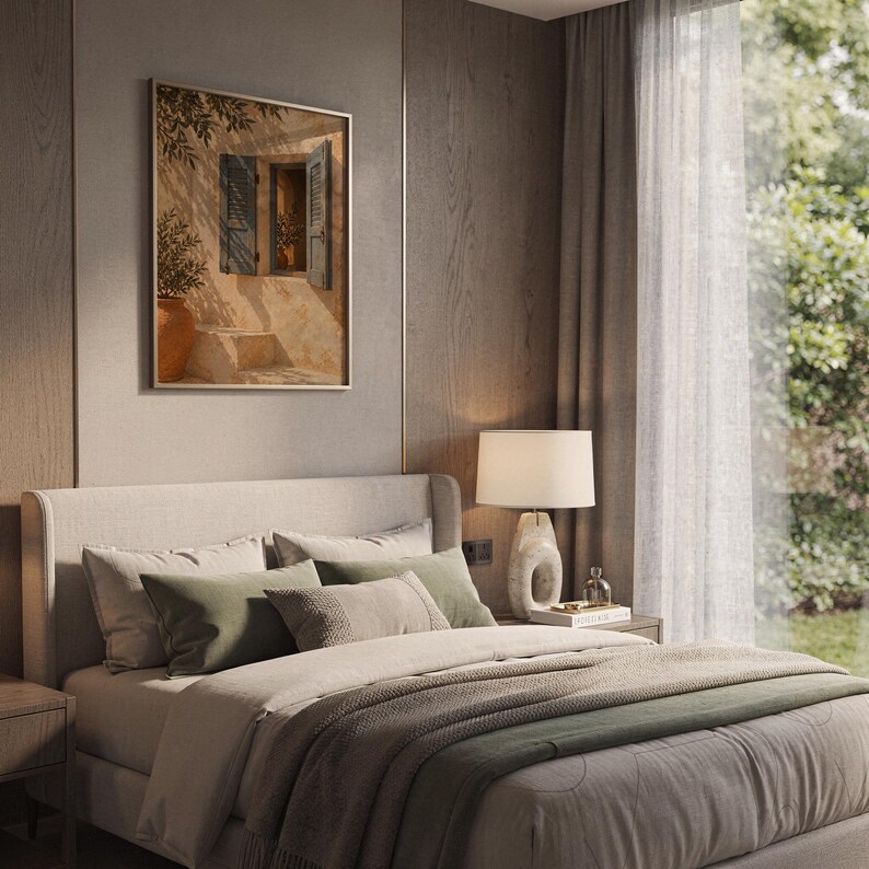 Mediterranean blue shutter wall art print leaning on a wooden desk against a warm beige wall in soft window sunlight.
