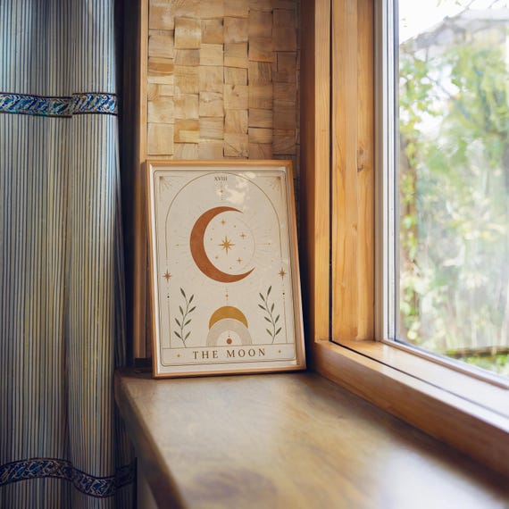 Minimalist crescent moon tarot card print framed on wooden window sill with natural light.