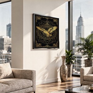Celestial owl wall art print standing on a white kitchen counter beside potted herbs.