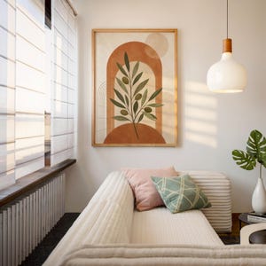Mid century olive branch art displayed in bright sunlit cozy interior room