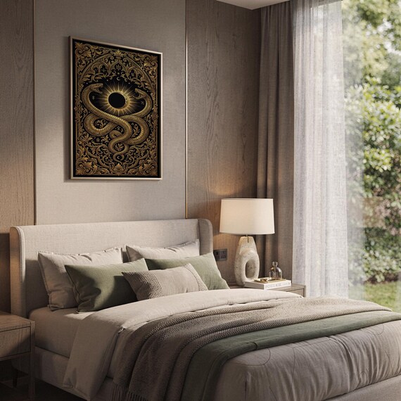 Occult snake wall art print hanging above a bed with sage green pillows in a calm neutral bedroom.