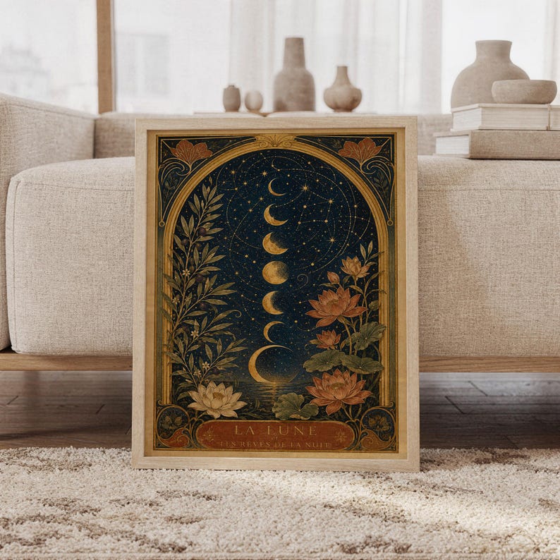 Moon phase wall art print featuring deep navy blue, antique gold, olive green, warm rust, and cream tones, glowing lunar phases, constellations, lotus flowers, and Art Nouveau botanical details, framed and leaning against a beige sofa on a textured rug in a bright Scandinavian living room.