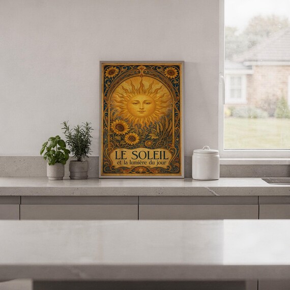 Art nouveau sunflower wall art print in a white frame leaning against a gray sofa on a sunlit wooden floor.