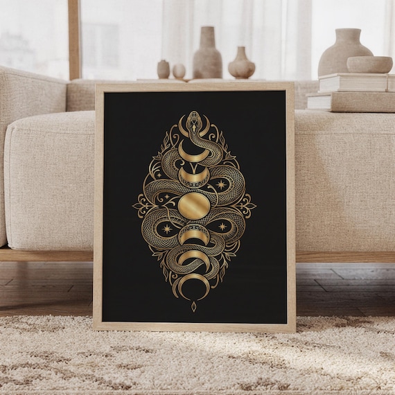 Gold snake moon phase wall art print featuring intricate metallic gold snakes, crescent moons, stars, and ornamental botanical details on a deep black background, framed and leaning against a beige sofa on a textured rug in a bright Scandinavian living room.