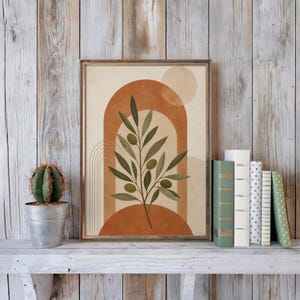 Earthy olive branch print on rustic shelf with books and cactus