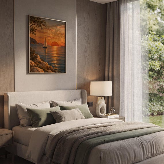 Sunset sailboat wall art print hanging above a bed with sage green pillows in a calm neutral bedroom.