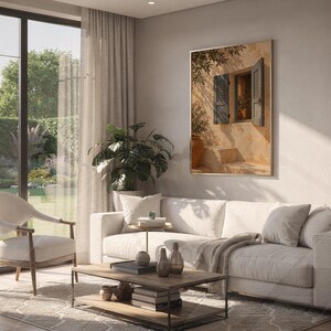 Mediterranean blue shutter wall art print hanging above a white sofa in a living room with garden views.