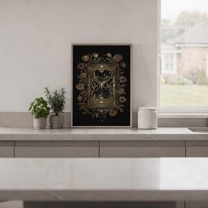 Gothic hourglass wall art print hanging in a high-rise apartment living room with a city skyline view.