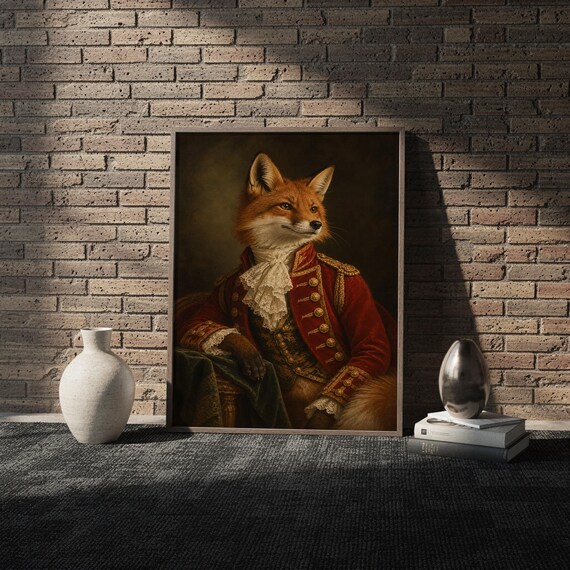 Fox portrait wall art print in a white frame leaning against a gray sofa on a sunlit wooden floor.