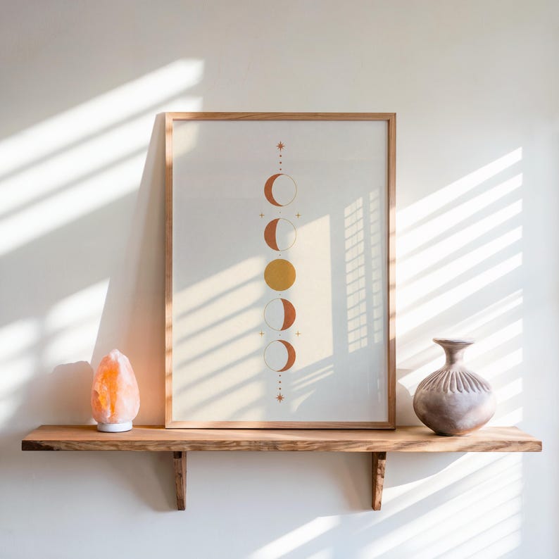 Moon phases print on floating rustic shelf with window blind shadows