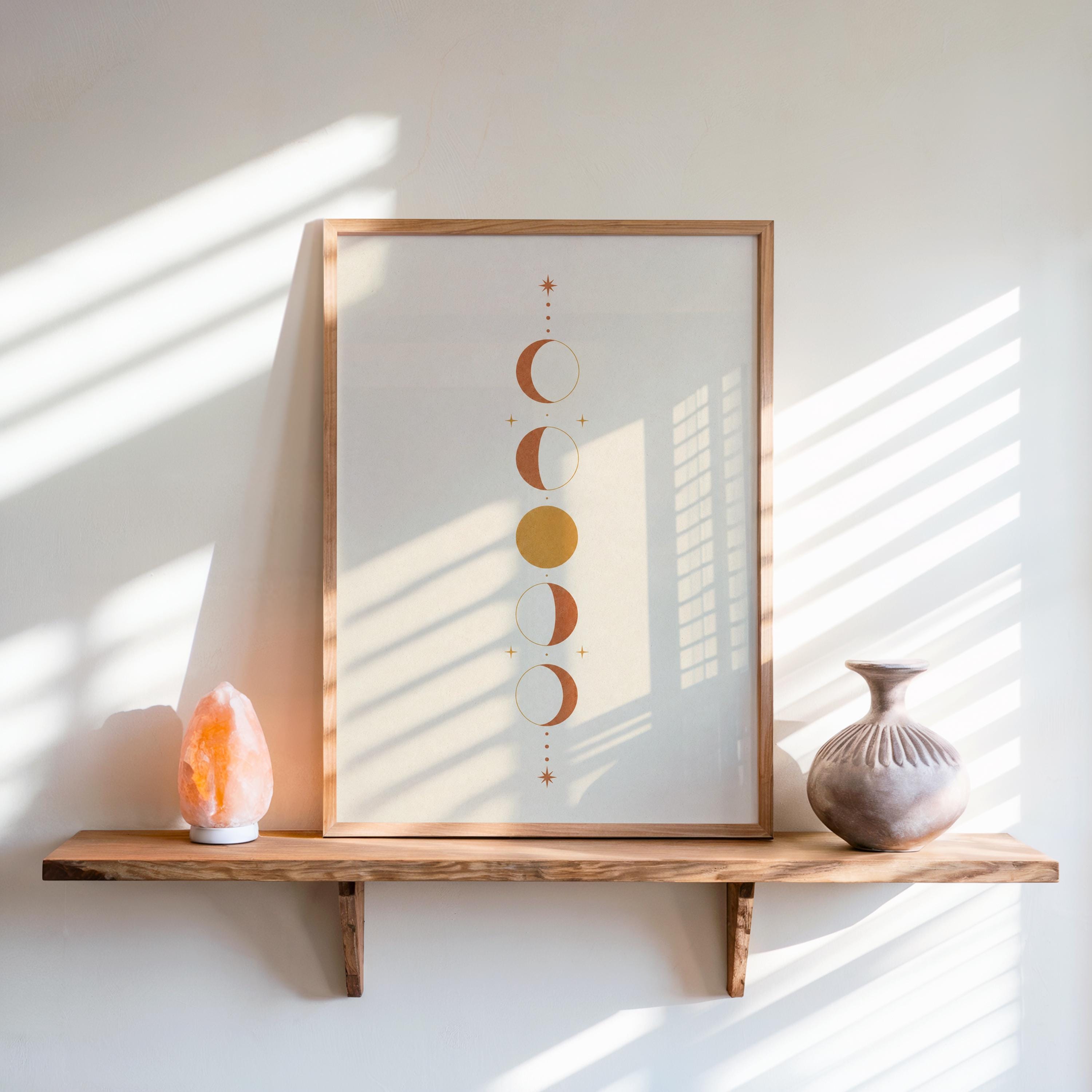 Moon phases print on floating rustic shelf with window blind shadows