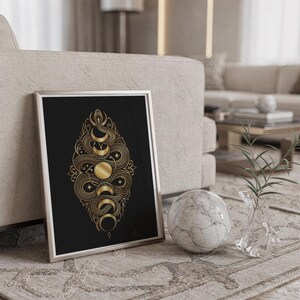 Gold snake moon phase wall art print standing on a countertop in a modern white kitchen.