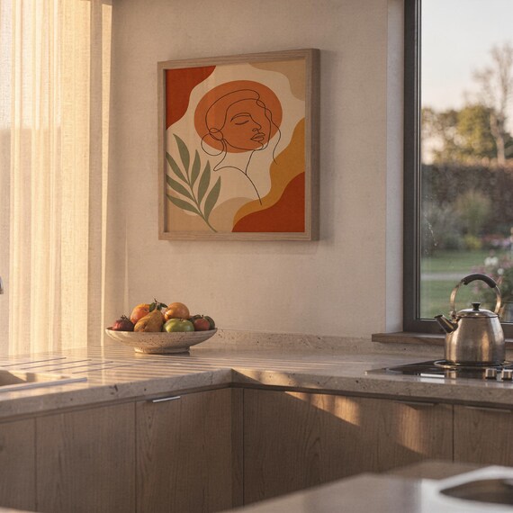 Abstract line art face print hanging in a high-rise apartment living room with a city skyline view.