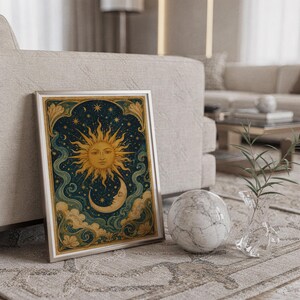 Celestial sun and moon wall art print standing on a countertop in a modern white kitchen.