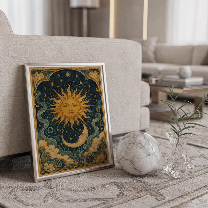 Celestial sun and moon wall art print standing on a countertop in a modern white kitchen.