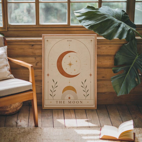 Vintage style celestial tarot poster framed in cozy rustic room with green indoor plants.