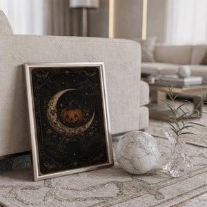 Vintage halloween moon wall art print standing on a countertop in a modern white kitchen.