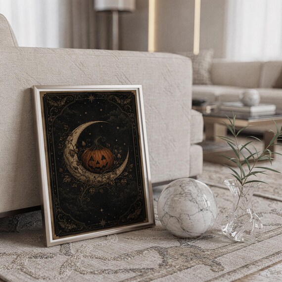 Vintage halloween moon wall art print standing on a countertop in a modern white kitchen.