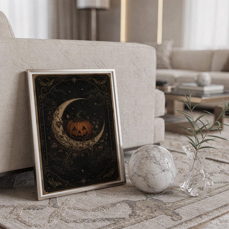 Vintage halloween moon wall art print standing on a countertop in a modern white kitchen.