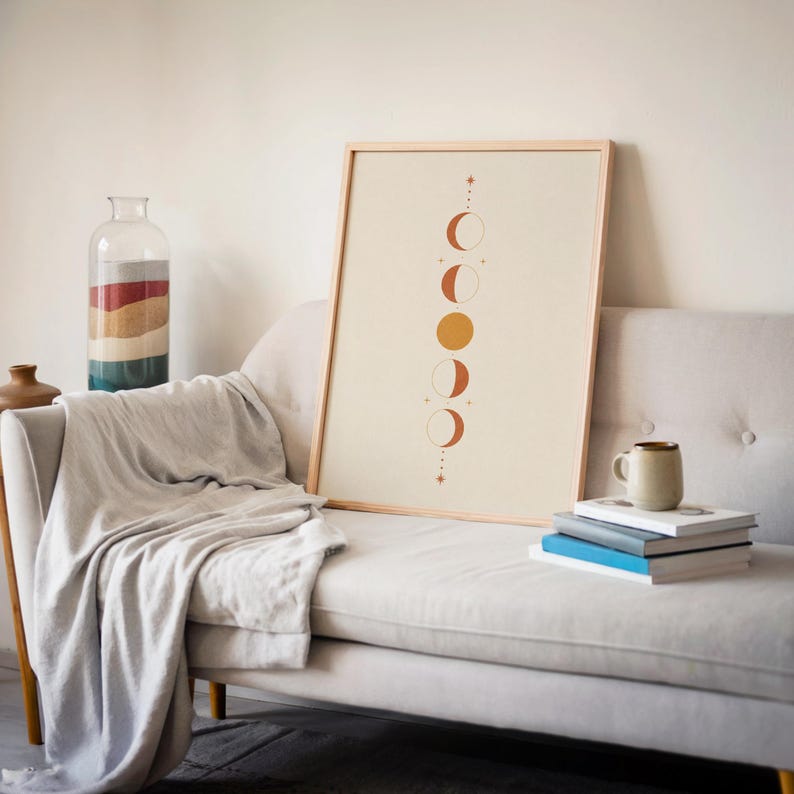 Mystical celestial print leaning against wall on soft gray sofa