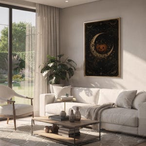 Vintage halloween moon wall art print hanging above a white sofa in a living room with garden views.