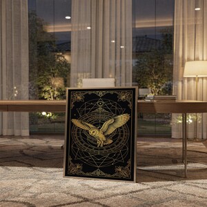 Celestial owl wall art print standing on a wooden desk in a home office in warm evening light.