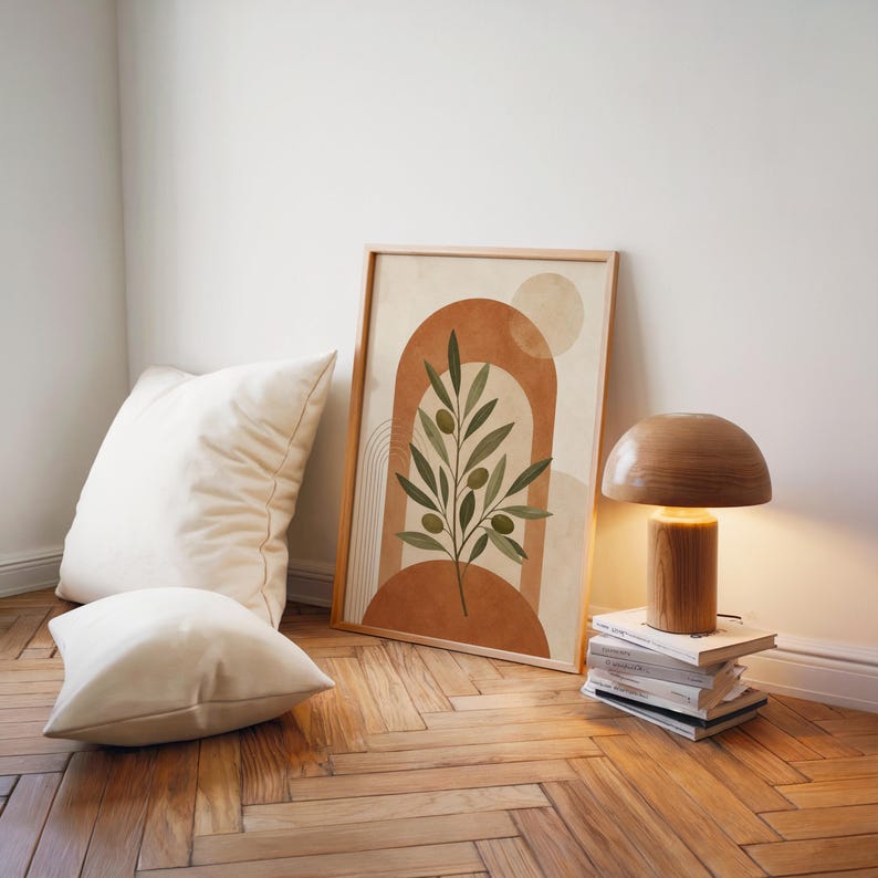 Minimalist terracotta arch print set on floor beside modern lamp and cushions