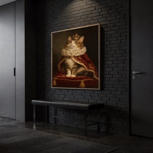 Royal cat portrait wall art print hanging above a dark wood console and jute rug in a warm neutral interior.