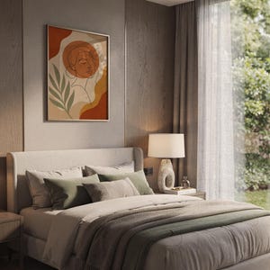 Abstract line art face print hanging above a bed with sage green pillows in a calm neutral bedroom.