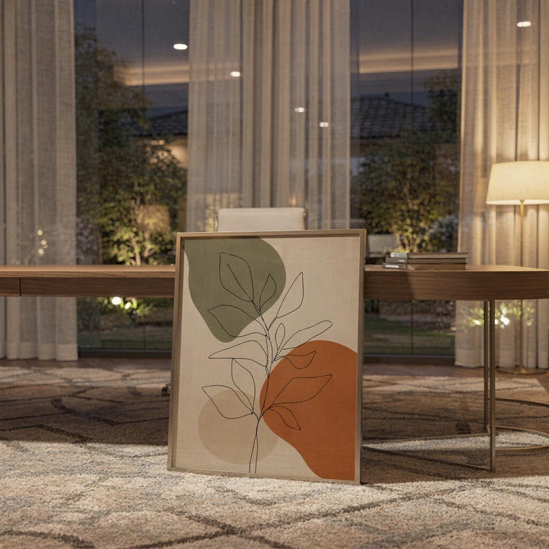 Framed botanical art print leaning on a shelf in a study room with soft ambient evening light.