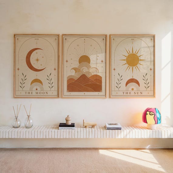 Set of 3 framed celestial wall art prints featuring The Moon, desert dunes, and The Sun hanging above a bench.