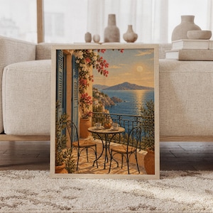 Mediterranean balcony wall art print featuring sun-warmed terracotta, soft cream, ocean blue, coral pink bougainvillea, and a serene sea view with distant mountains, framed and leaning against a beige sofa on a textured rug in a bright Scandinavian living room.